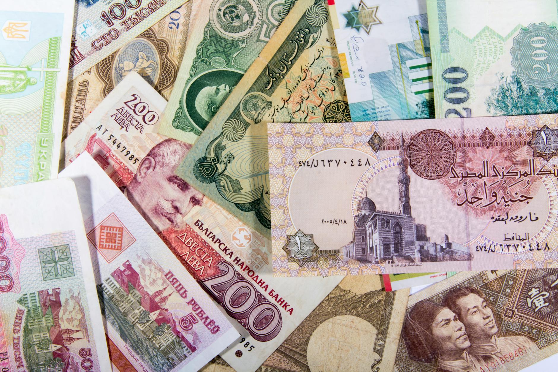A collection of various international banknotes, showcasing diverse currencies and designs.
